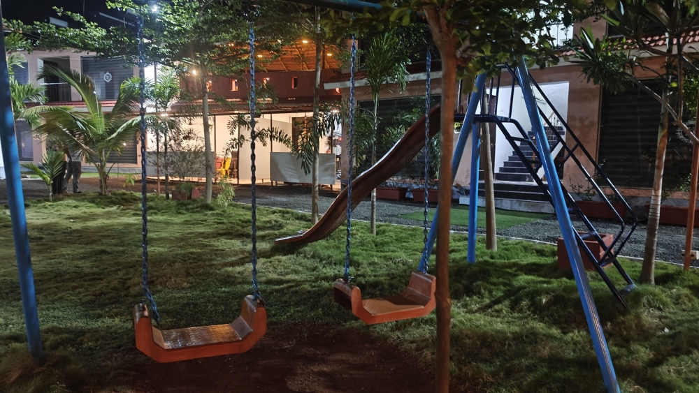 Opulence's resort view at night having small streetlight lamb in lawn